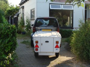 The Mini Camping pop up trailer behind a Smart